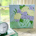 Purple and White Flowers in Blue Glass Vase